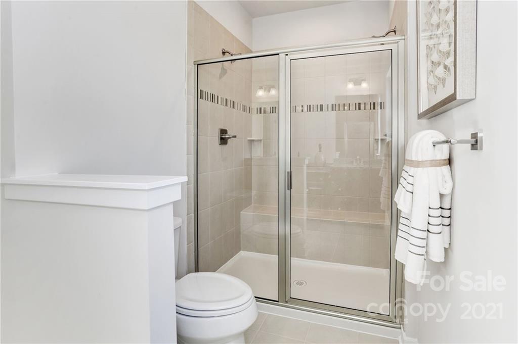 2007 Dornoch Road, Unit 1033B Tega Cay, SC 29708 - Photo 7 of 12 a bathroom with a shower and a toilet