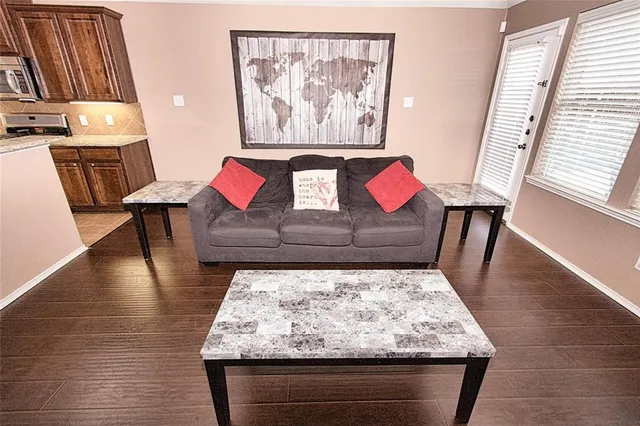 a living room with furniture and wooden floor