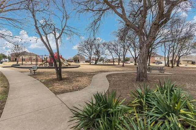 a view of outdoor space with playground and green space