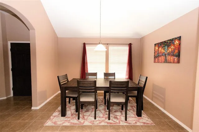 a view of a dining room with furniture and window