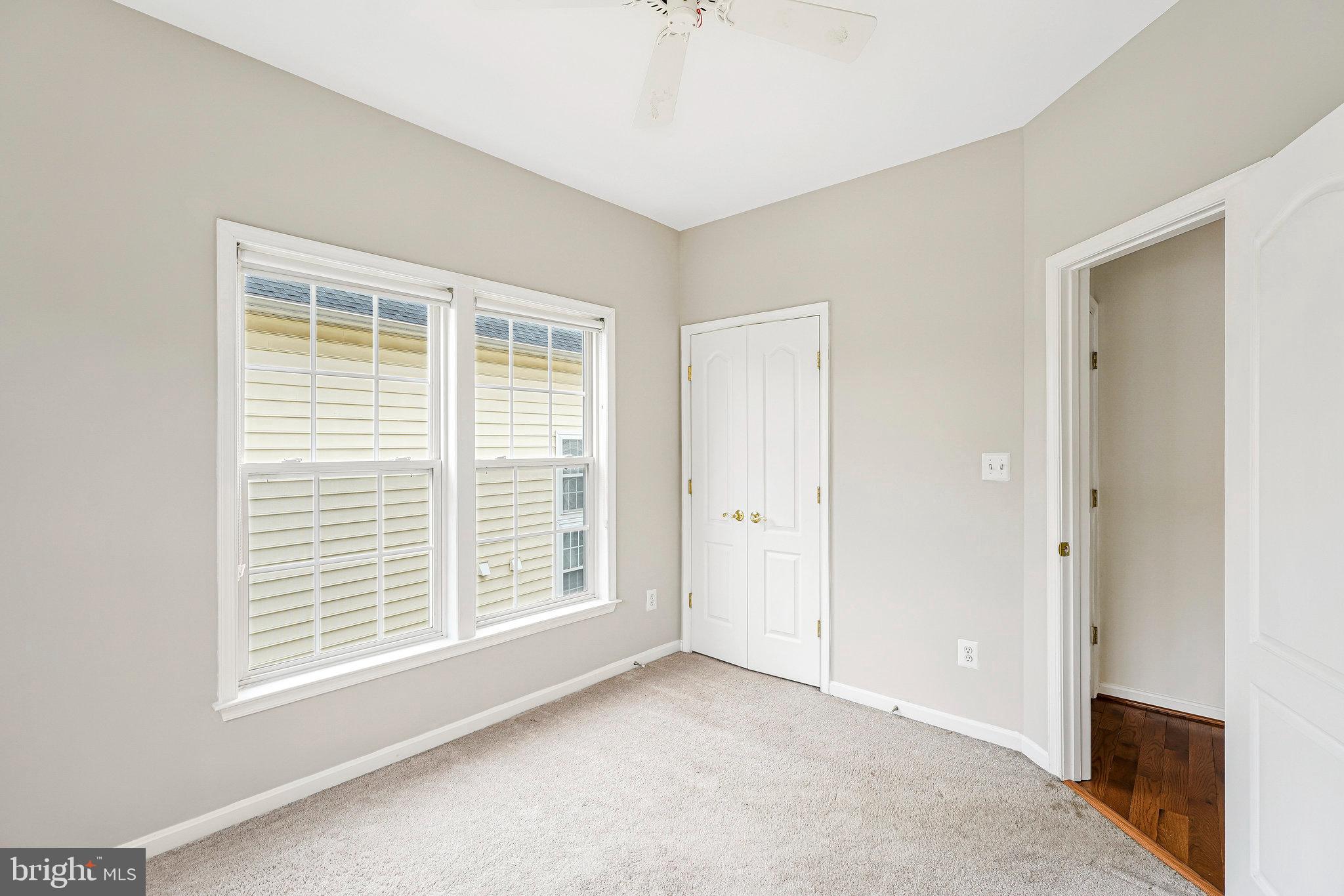 21946 Windover Drive Broadlands, VA 20148 - Photo 27 of 45 a view of an empty room with a fireplace and a window