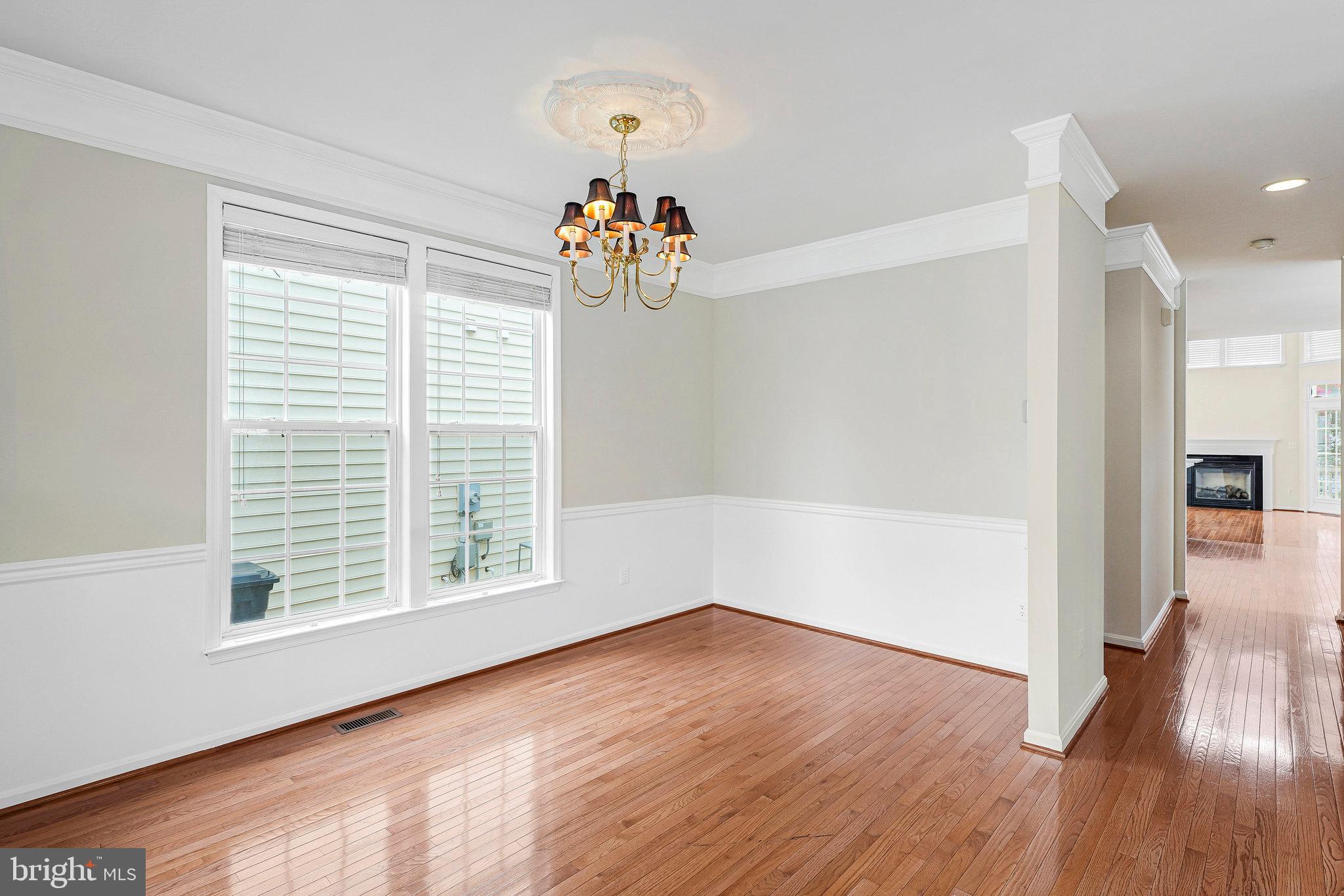 21946 Windover Drive Broadlands, VA 20148 - Photo 5 of 45 wooden floor in an empty room with a window