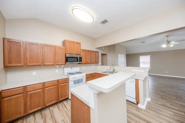a kitchen that has a sink and a stove in it