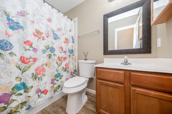 a bathroom with a sink toilet and shower