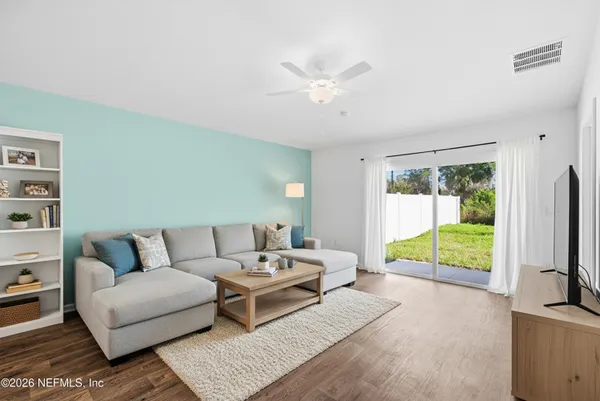 a living room with furniture and a flat screen tv