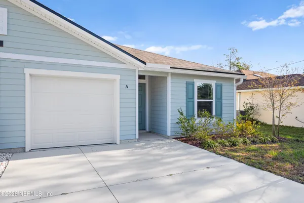 a view of a house with backyard and garden