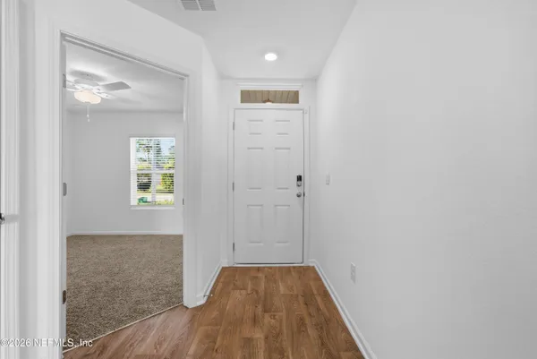 a view of hallway with wooden floor
