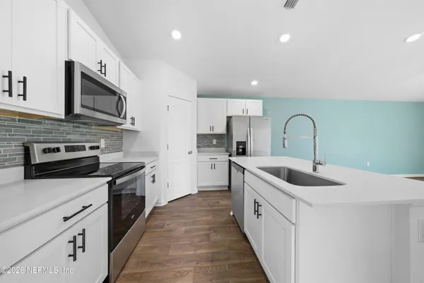 a kitchen with stainless steel appliances granite countertop a sink and stove top oven