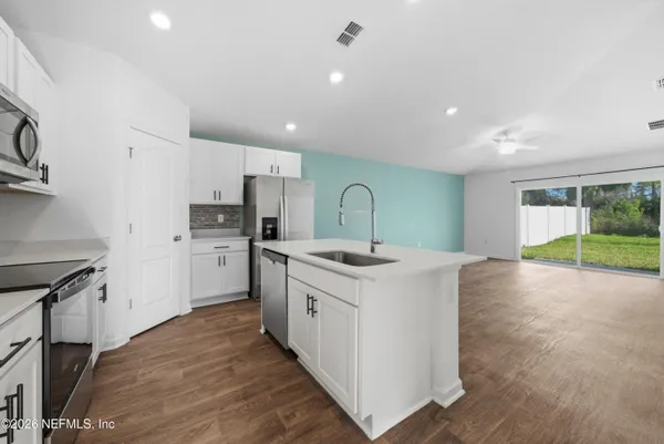 a kitchen with a sink stove and refrigerator