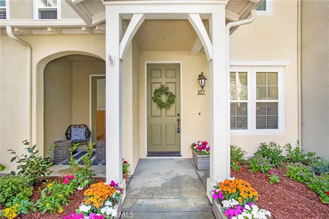 a front view of a house with flowers