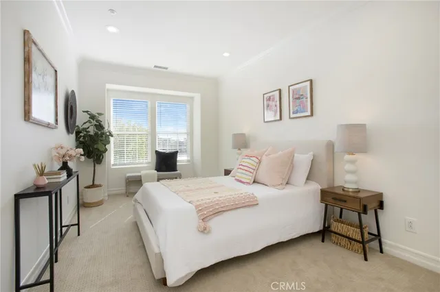 a bedroom with a bed and a lamp with the wooden floor
