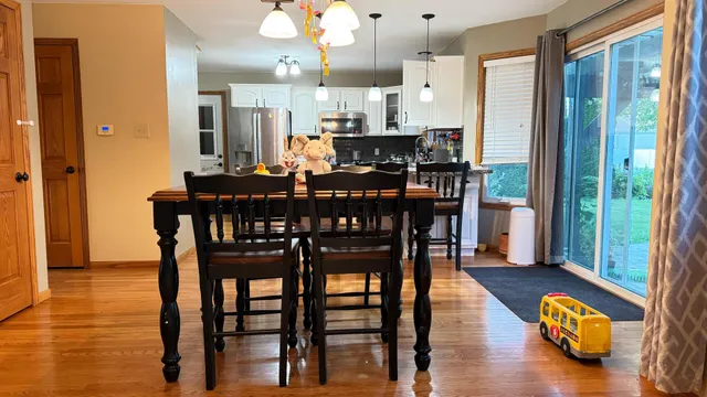 a view of a dining room with furniture and wooden floor