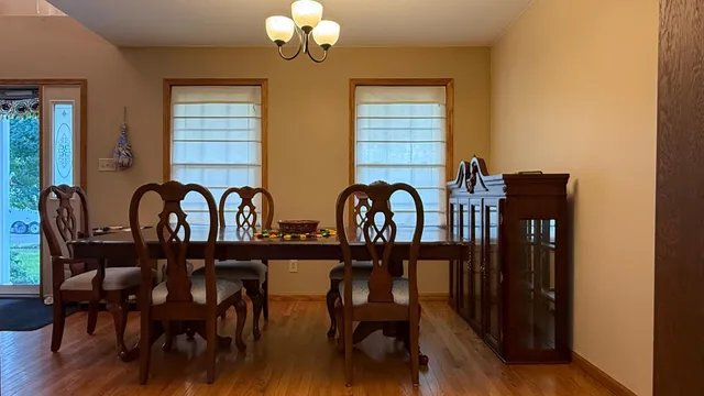 a view of a dining room with furniture and chandelier