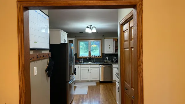 a kitchen with a refrigerator and a stove
