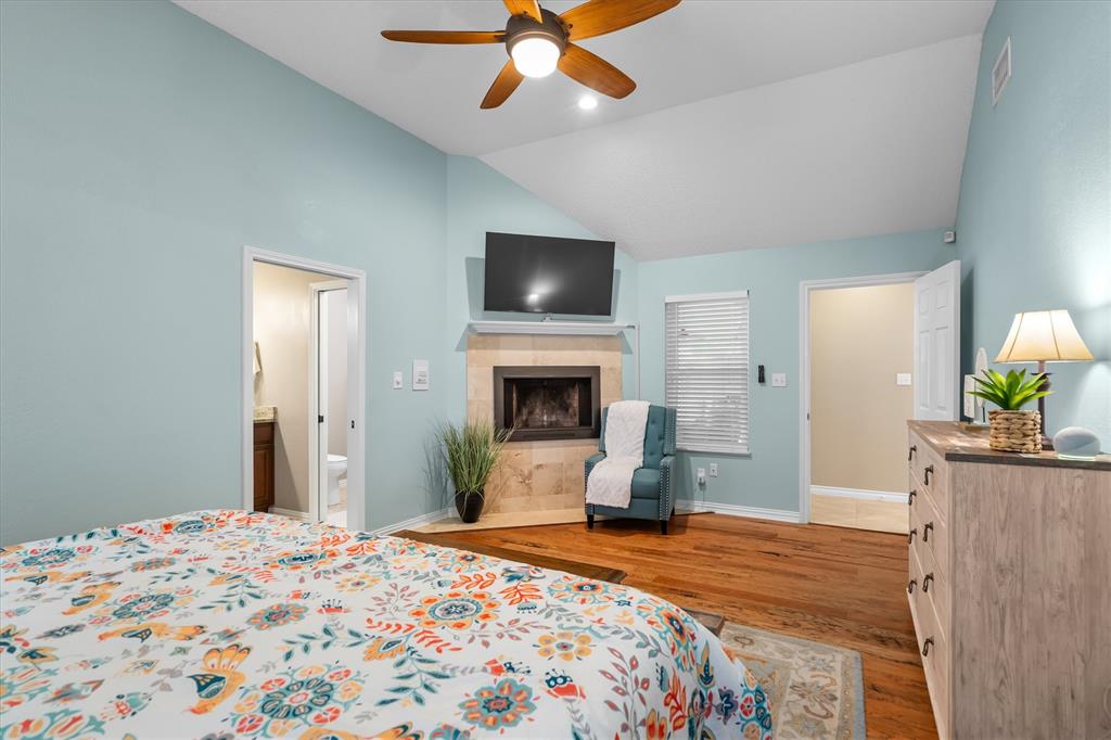410 Simmons Road Double Oak, TX 75077 - Photo 18 of 40 Spacious primary suite with fireplace and sitting area — a true sanctuary.