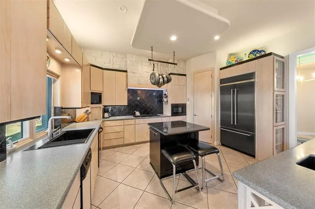 a large kitchen with a table and chairs