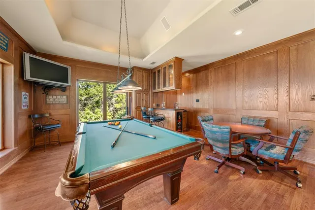 a room with furniture pool table and windows