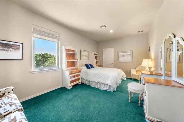 a bedroom with bed and window