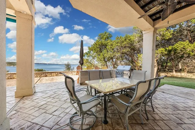 a view of a patio with a table and chairs