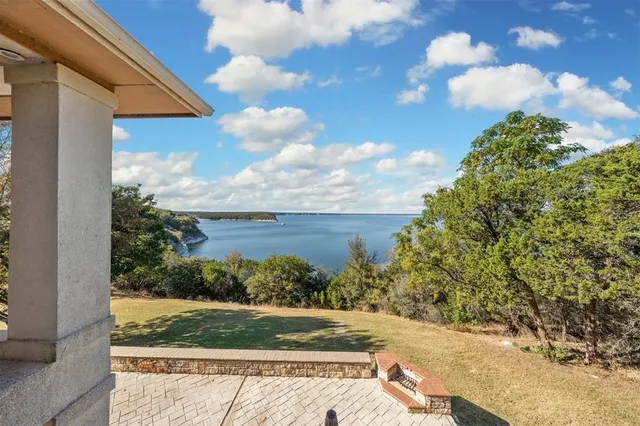 a view of a yard with wooden fence