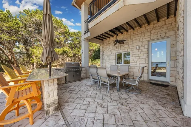 a view of a patio with table and chairs and potted plants