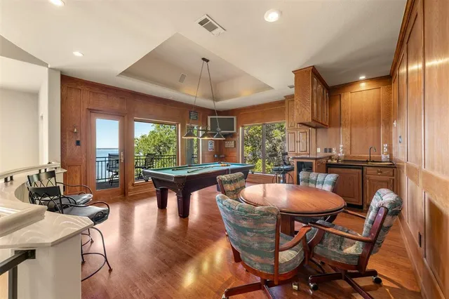 a dining room with furniture and wooden floor