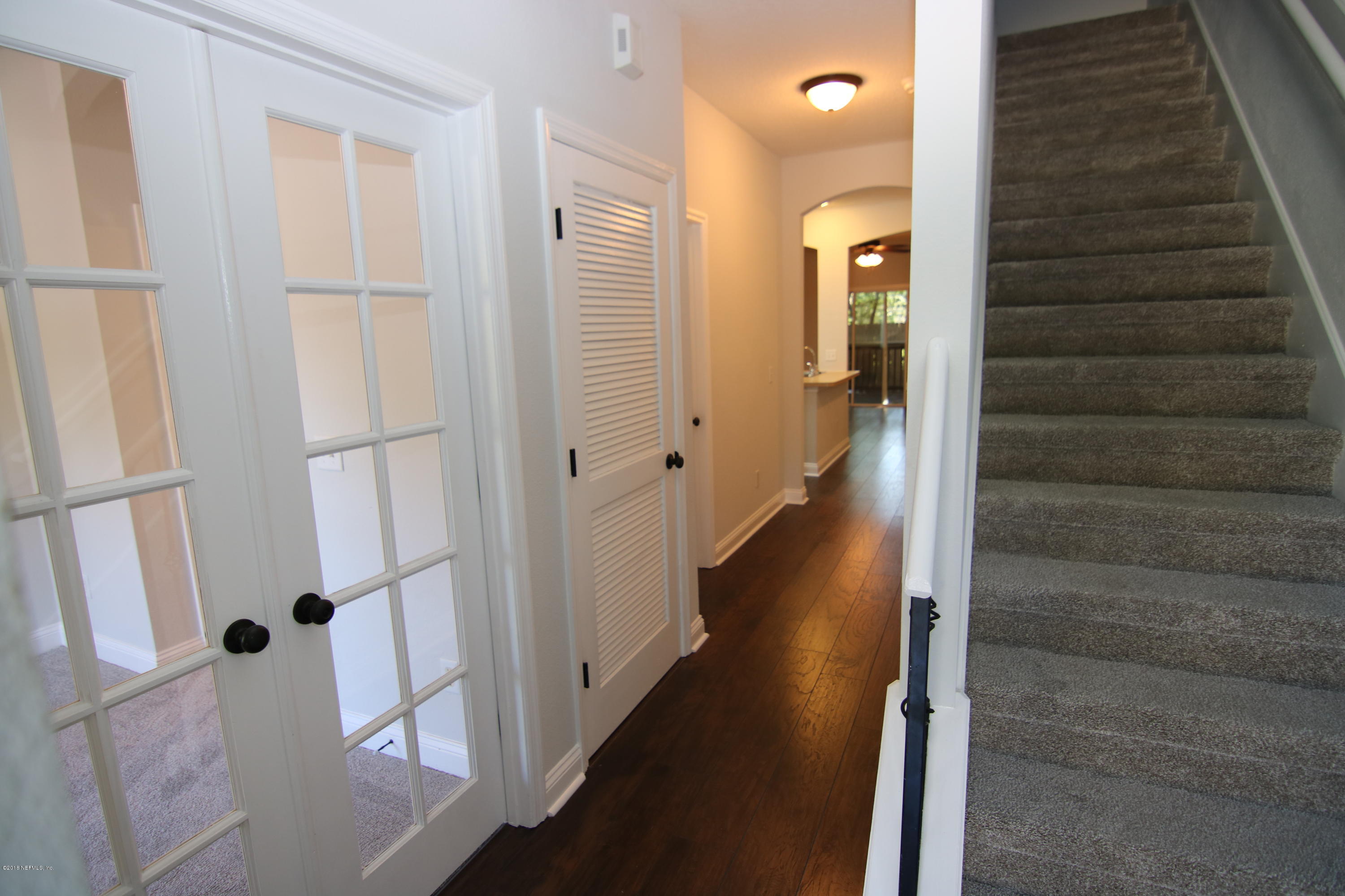 4661 Barnes Road South Jacksonville, FL 32207 - Photo 14 of 22 a view of a hallway with wooden floor and staircase