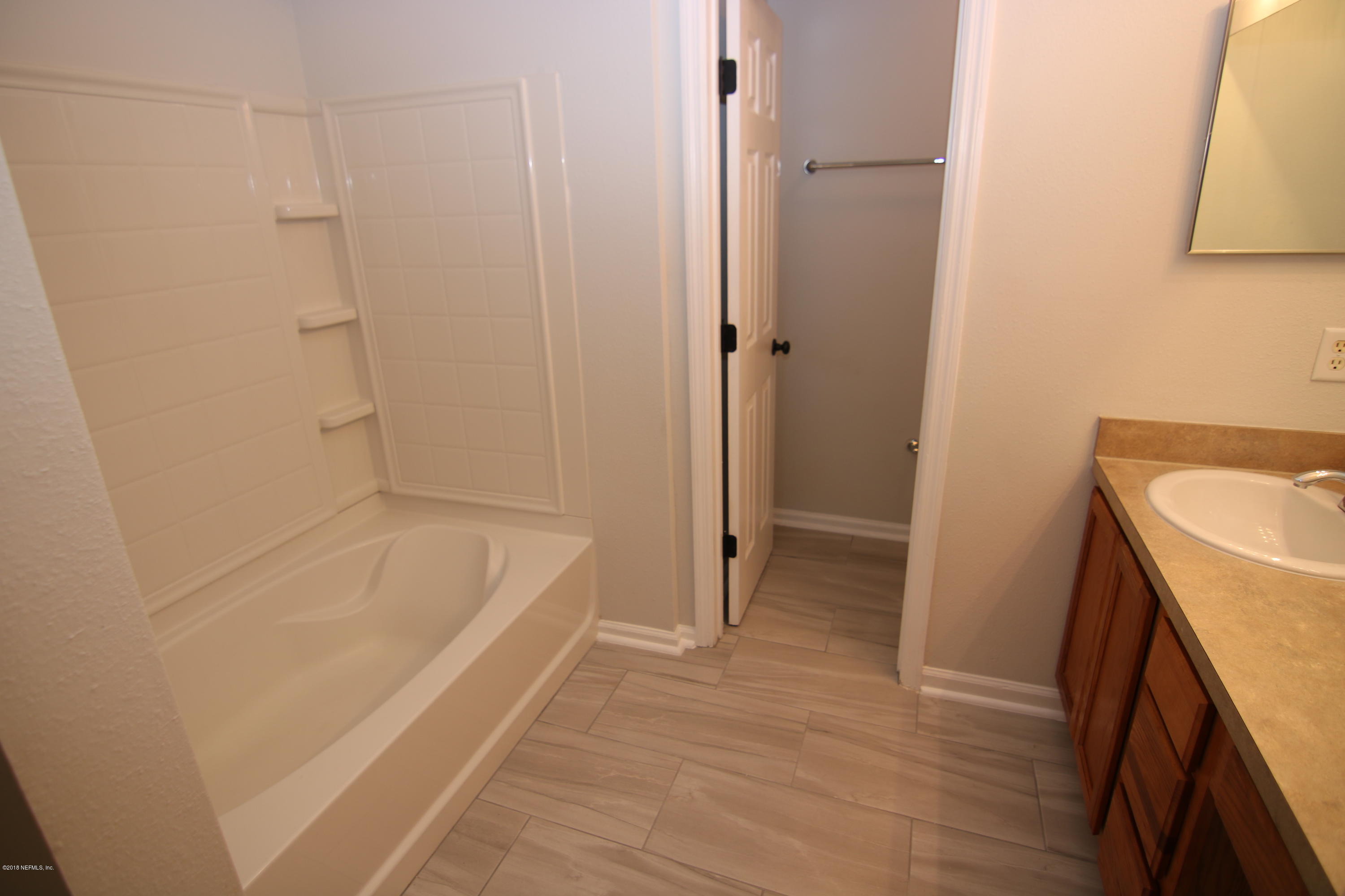 4661 Barnes Road South Jacksonville, FL 32207 - Photo 15 of 22 a bathroom with a tub a sink and a shower