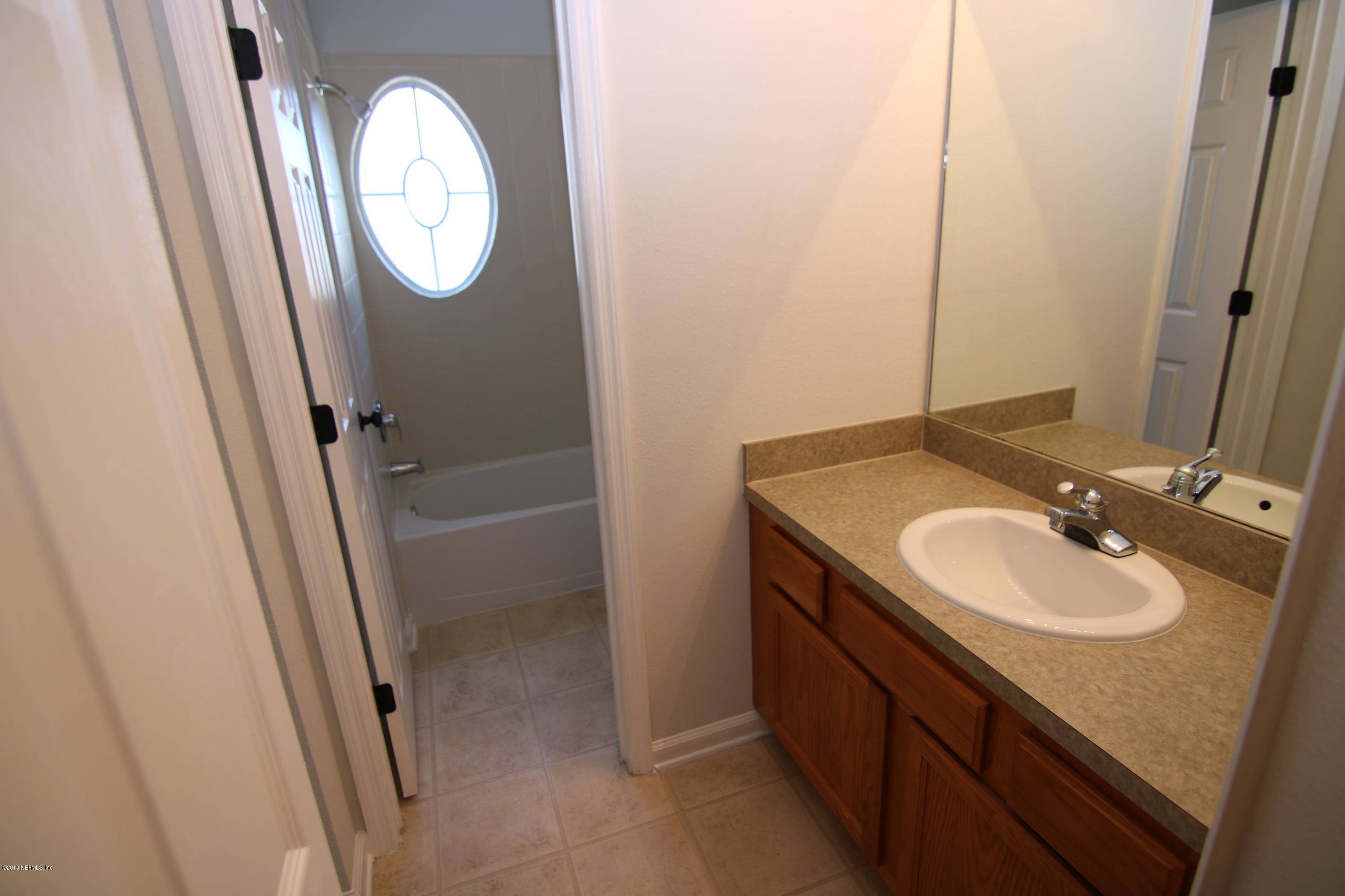 4661 Barnes Road South Jacksonville, FL 32207 - Photo 17 of 22 a bathroom with a granite countertop sink toilet and a mirror