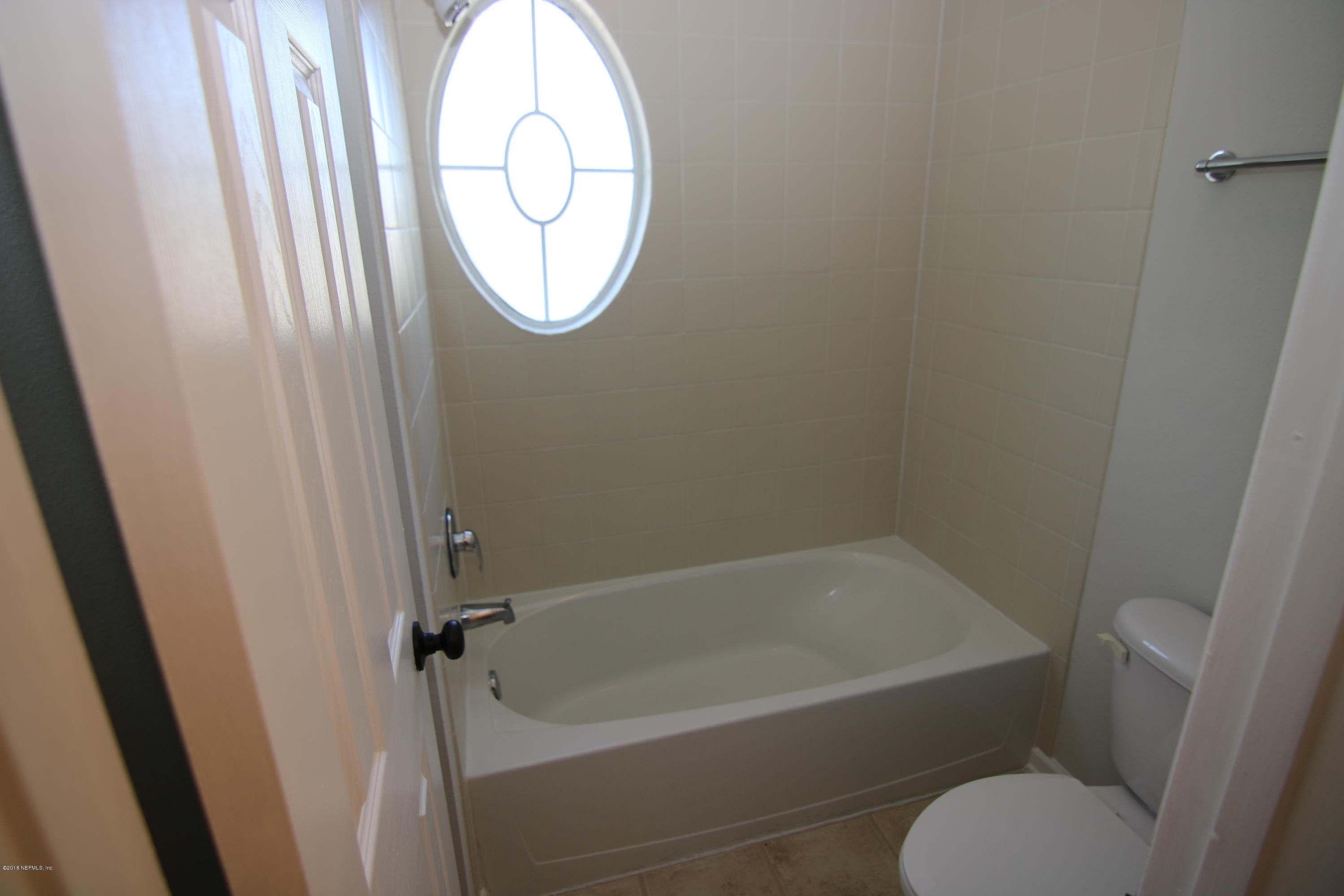 4661 Barnes Road South Jacksonville, FL 32207 - Photo 18 of 22 a bathroom with a toilet and a bathtub