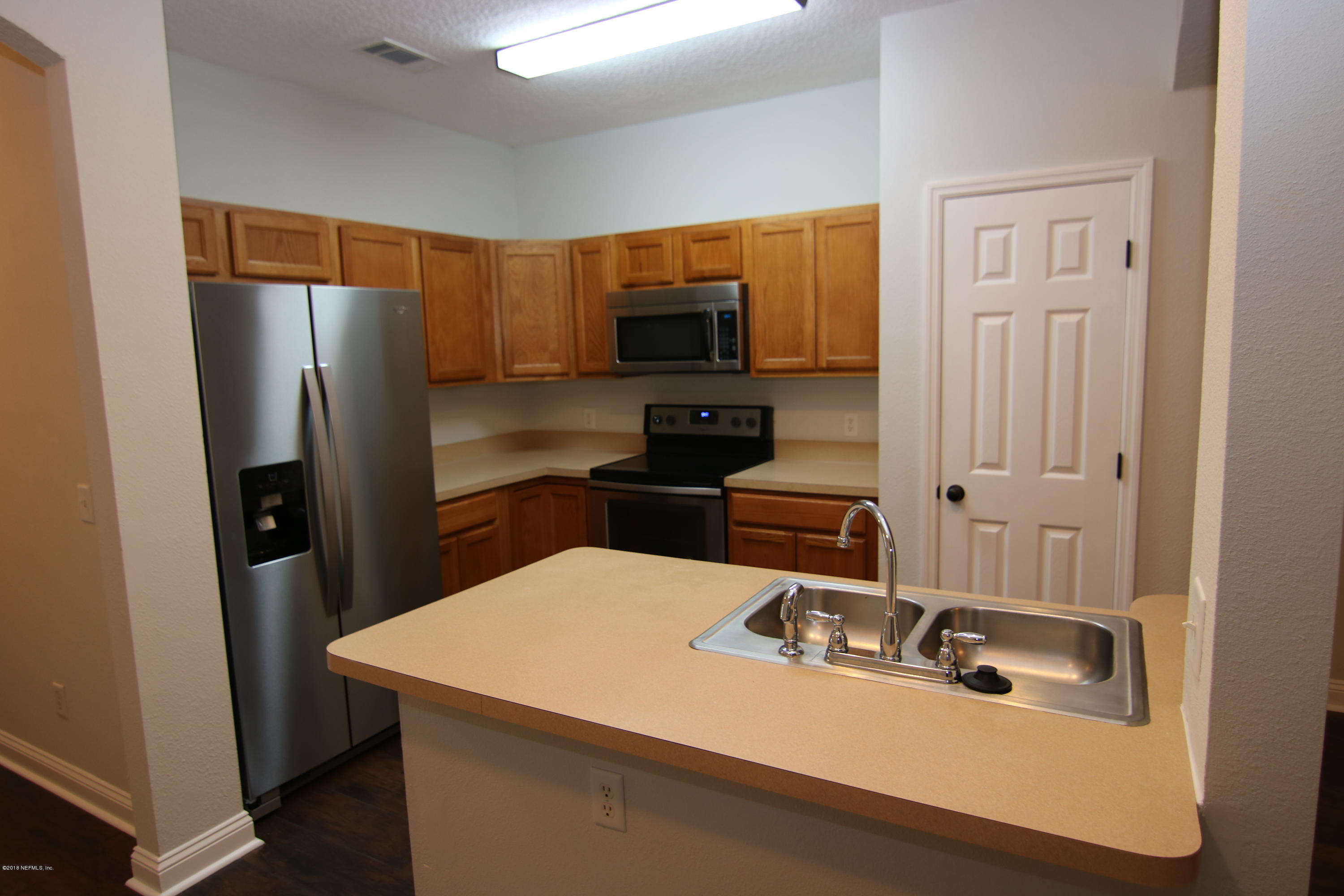 4661 Barnes Road South Jacksonville, FL 32207 - Photo 2 of 22 a room with a sink a refrigerator and a television