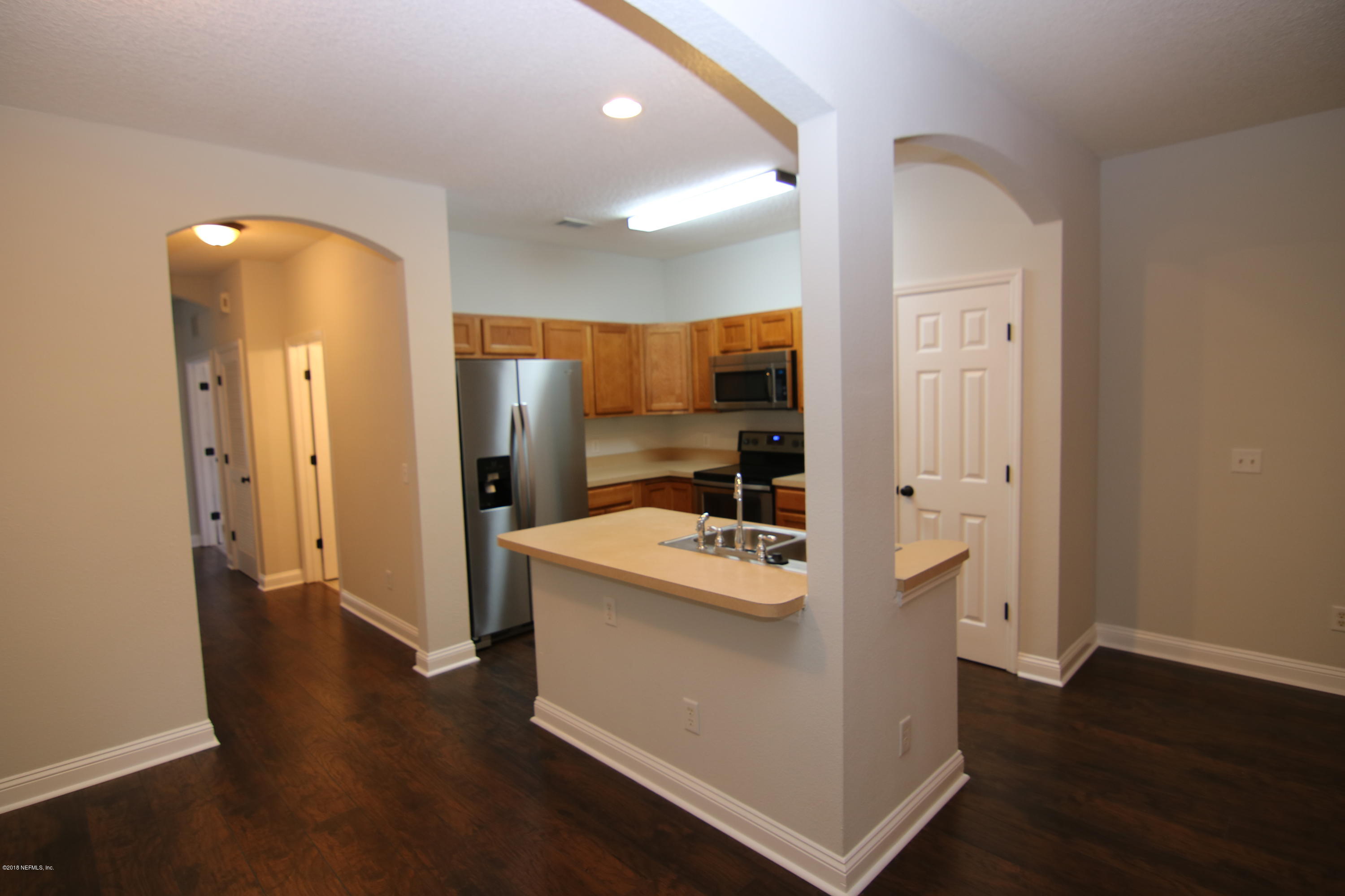 4661 Barnes Road South Jacksonville, FL 32207 - Photo 3 of 22 a view of a hallway with bathroom and wooden floor