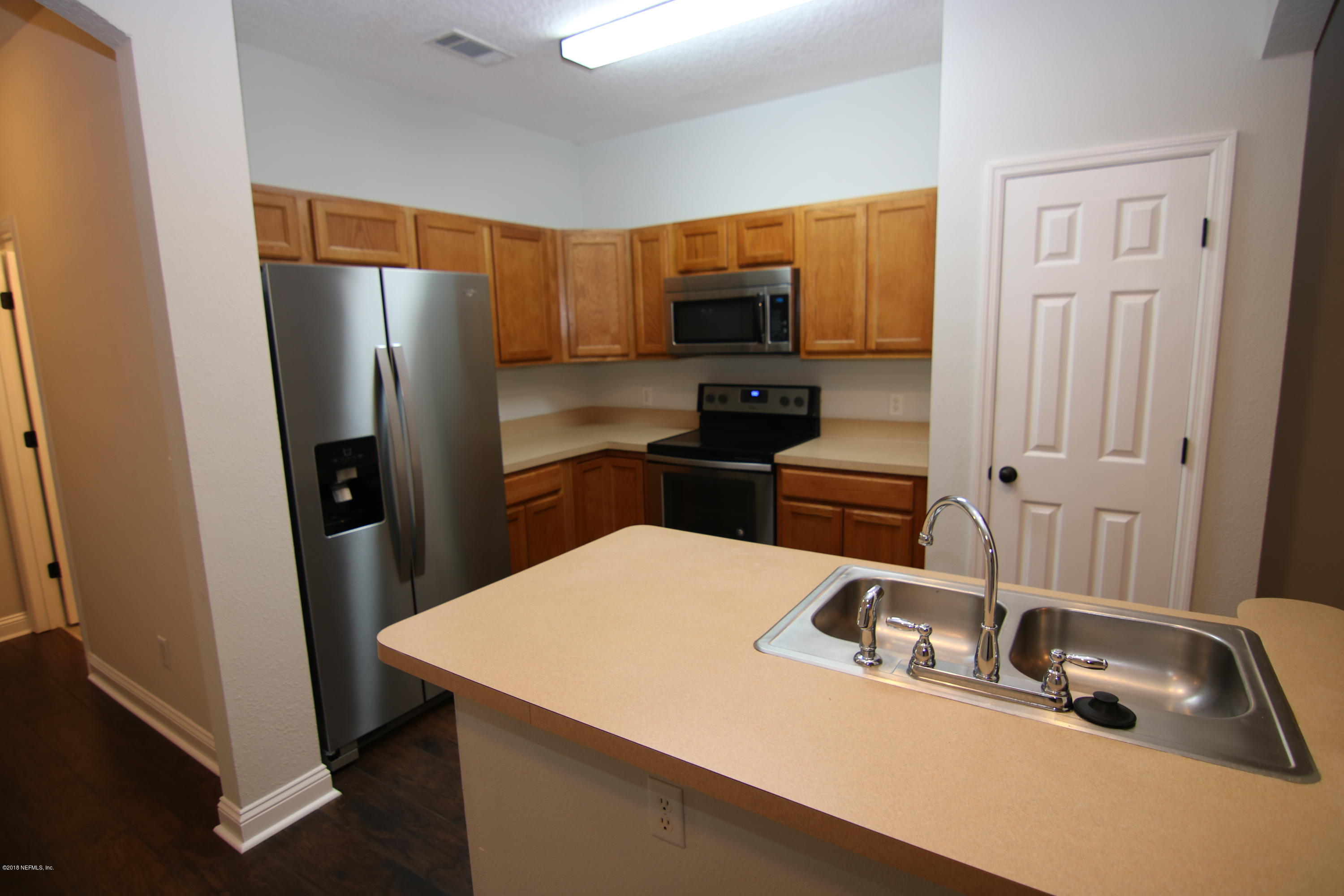 4661 Barnes Road South Jacksonville, FL 32207 - Photo 4 of 22 a kitchen with a sink a counter top space and stainless steel appliances
