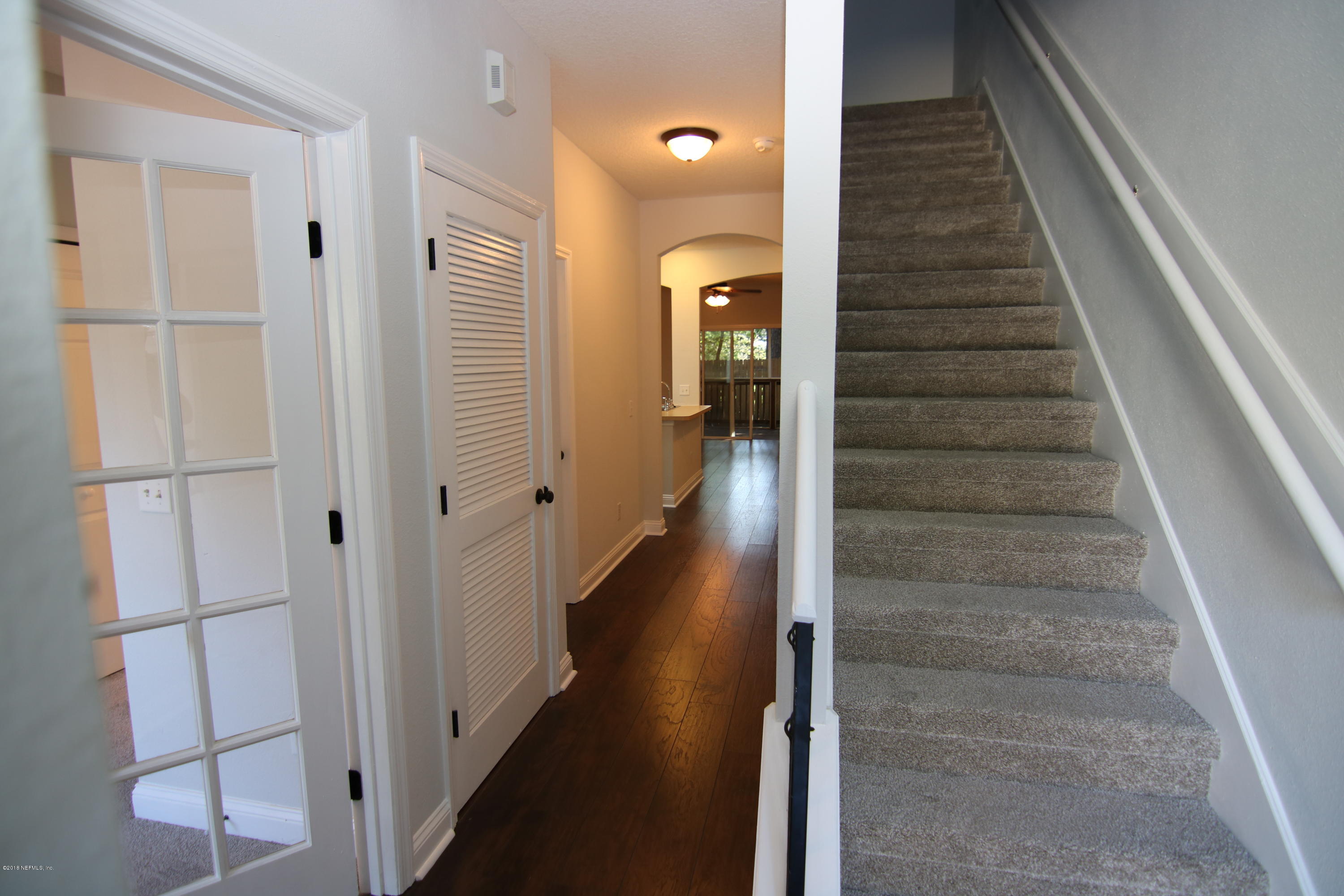 4661 Barnes Road South Jacksonville, FL 32207 - Photo 6 of 22 a view of a hallway with wooden floor and staircase
