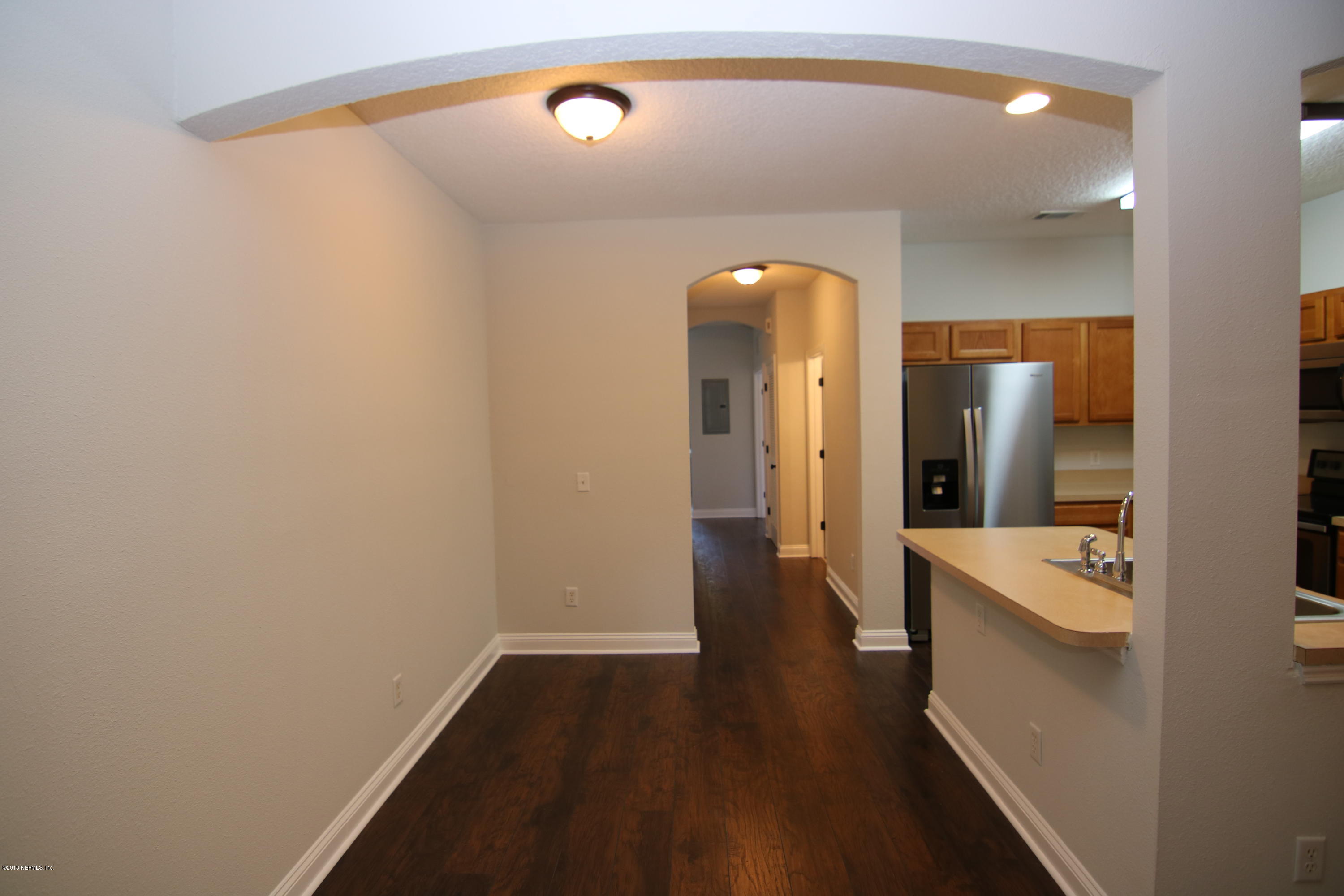 4661 Barnes Road South Jacksonville, FL 32207 - Photo 7 of 22 a view of a hallway with wooden floor and a bathroom