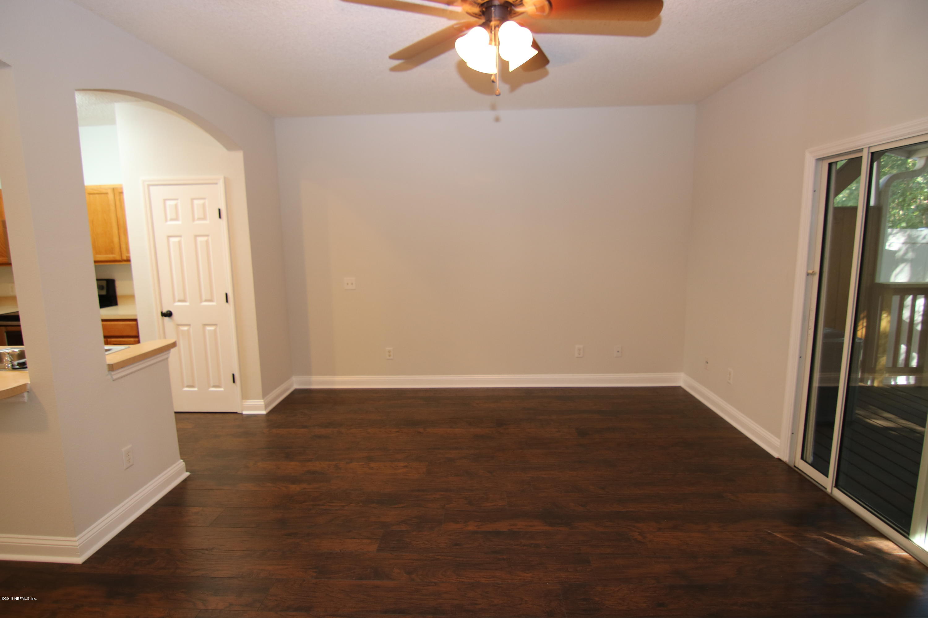 4661 Barnes Road South Jacksonville, FL 32207 - Photo 9 of 22 wooden floor in an empty room with a window