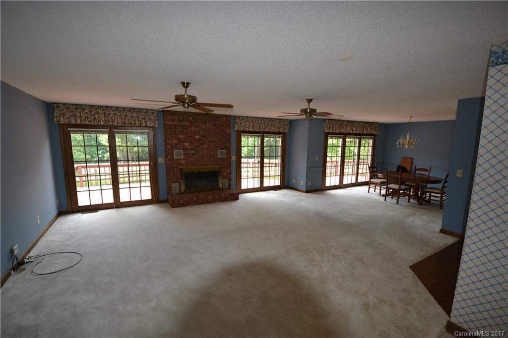 8147 Fairfield Forest Road Denver, NC 28037 - Photo 15 of 23 a view of an empty room with a fireplace and a window