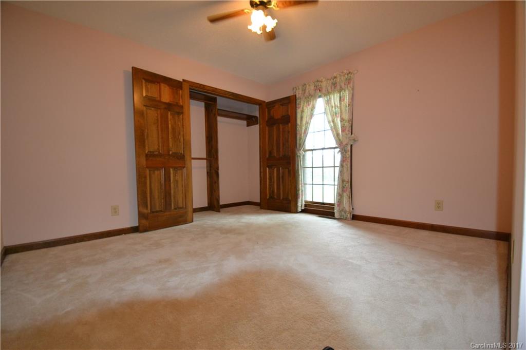 8147 Fairfield Forest Road Denver, NC 28037 - Photo 19 of 23 an empty room with windows and chandelier fan