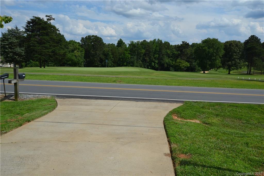 8147 Fairfield Forest Road Denver, NC 28037 - Photo 3 of 23 a view of a golf course with a lake