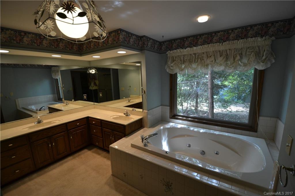 8147 Fairfield Forest Road Denver, NC 28037 - Photo 21 of 23 a bathroom with a double vanity sink and a bathtub