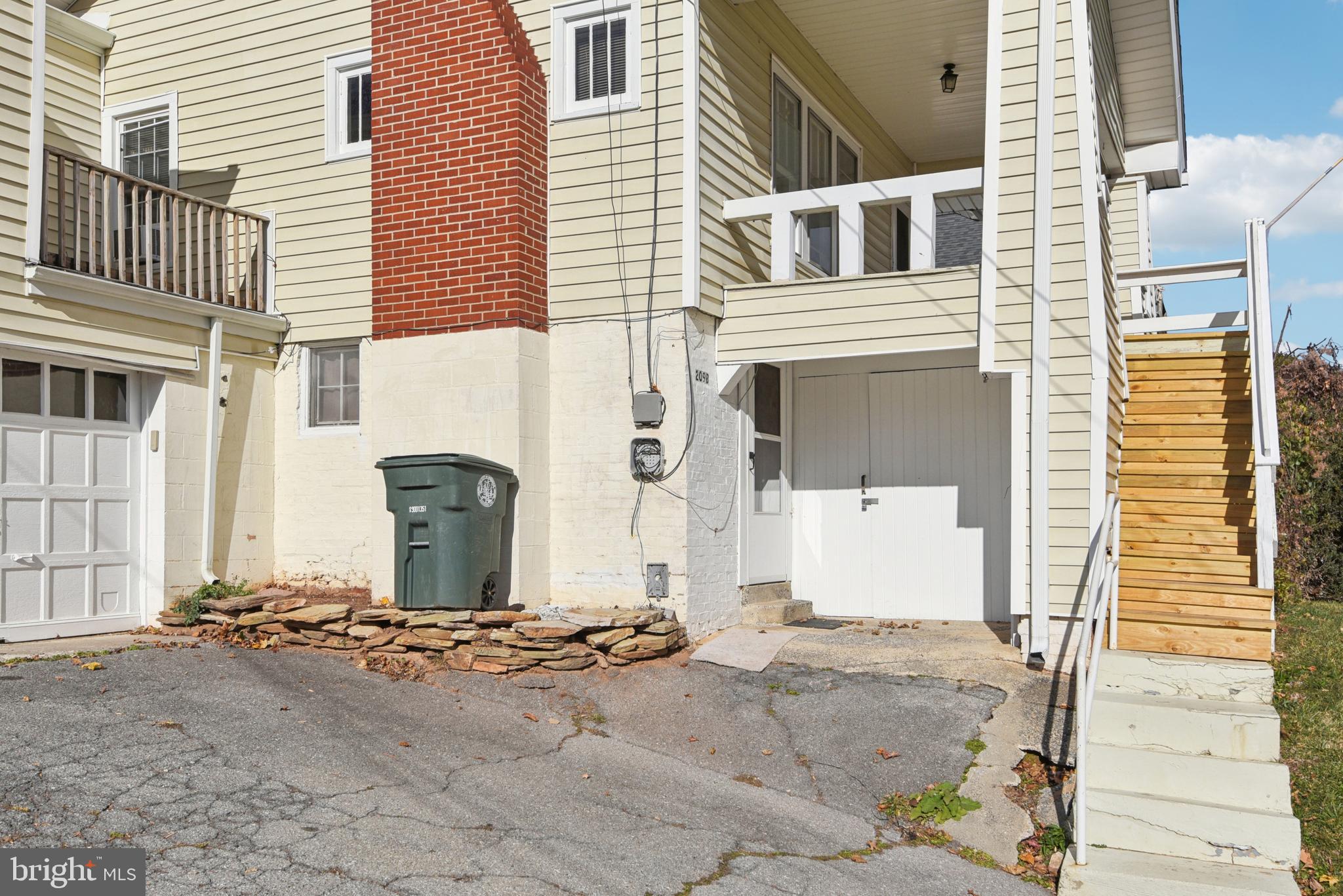 209 Locust Street, Unit B Frederick, MD 21703 - Photo 3 of 14 a front view of a house with a yard
