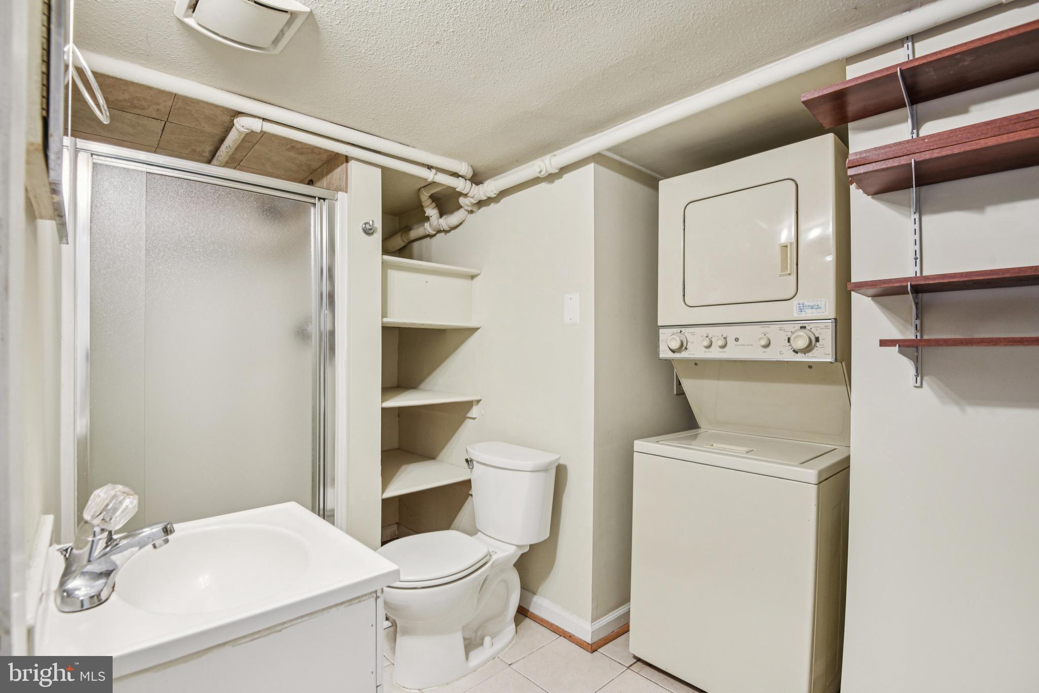 209 Locust Street, Unit B Frederick, MD 21703 - Photo 8 of 14 a bathroom with a sink a toilet and shower