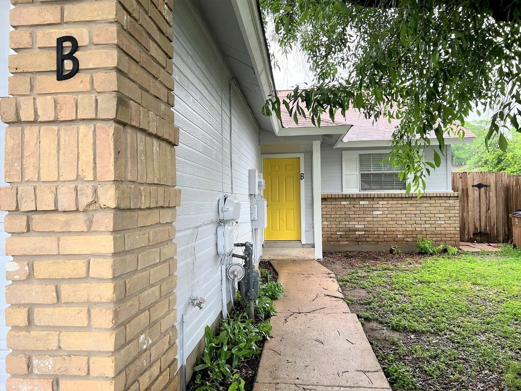 Doorway to property with brick siding