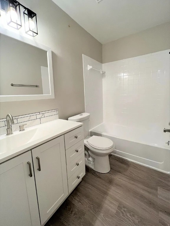12214 Thompkins Drive, Unit B Austin, TX 78753 - Photo 11 of 13 Full bathroom featuring washtub / shower combination, vanity, and dark wood-style flooring