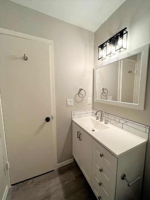 12214 Thompkins Drive, Unit B Austin, TX 78753 - Photo 12 of 13 Bathroom featuring vanity and dark wood-style flooring
