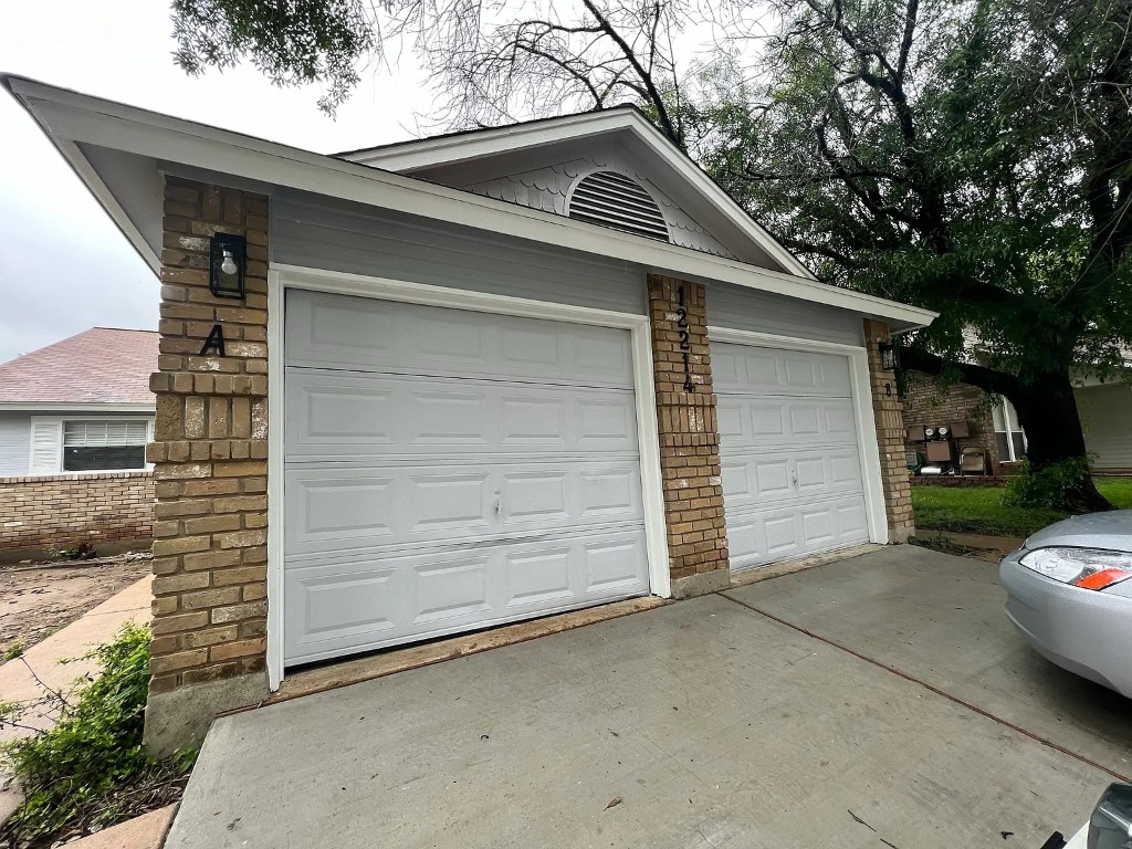 12214 Thompkins Drive, Unit B Austin, TX 78753 - Photo 2 of 13 Garage with driveway
