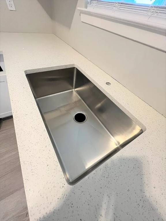 12214 Thompkins Drive, Unit B Austin, TX 78753 - Photo 6 of 13 Kitchen view of light stone countertops and a sink