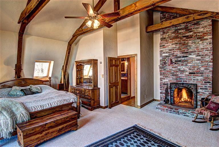 36 Torrey Road East Sandwich, MA 02537 - Photo 14 of 24 a bedroom with a bed next to a fireplace with a mirror