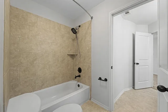 a bathroom with a granite countertop sink and a toilet