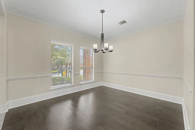 a view of a room with wooden floor and a window